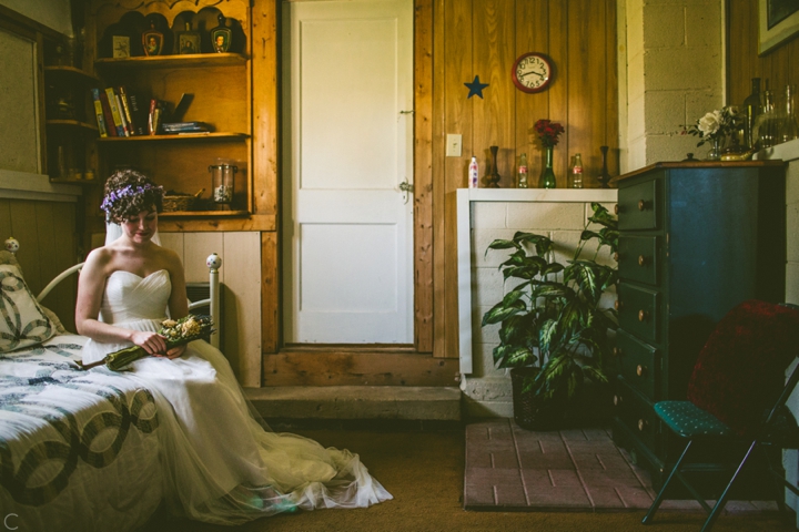 Bride sitting inside barn