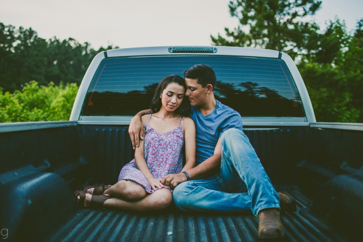 Couple sitting in bed of truck