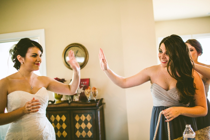 Bride and bridesmaid high-five