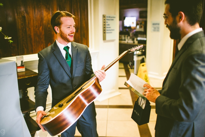 Groom receiving guitar present from bride