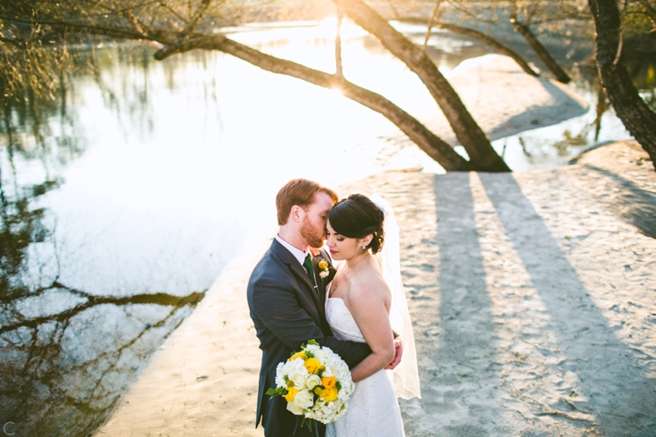 Bride and groom hugging on beach