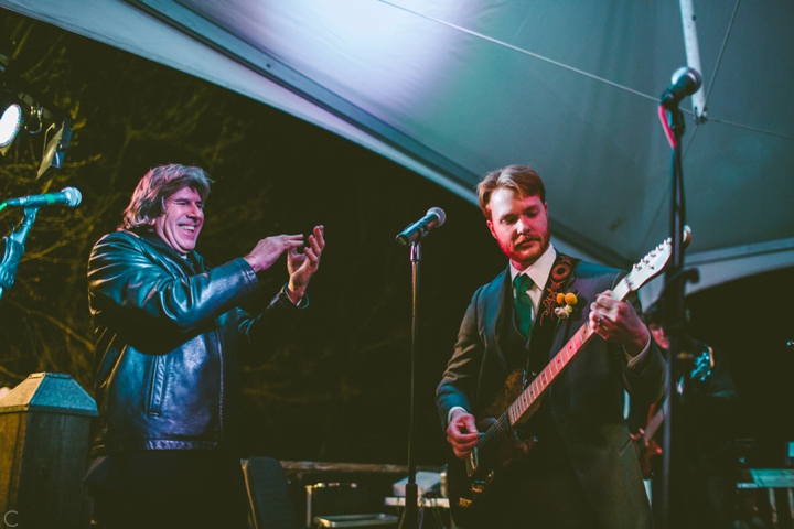 Groom playing guitar at wedding