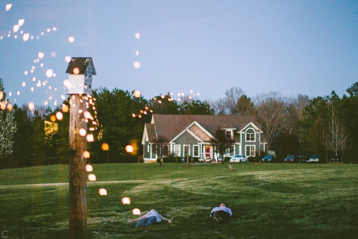 Kids laying in yard at wedding reception