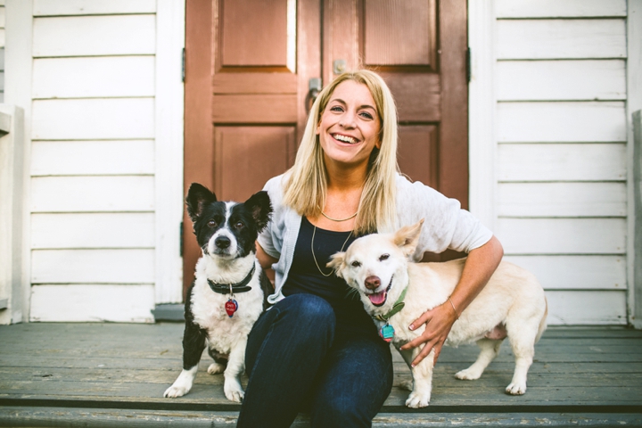 Girl smiling with Corgis