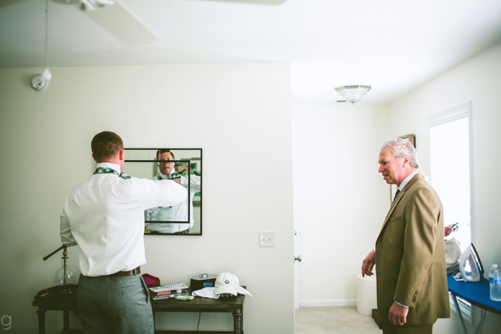 Groom putting on tie