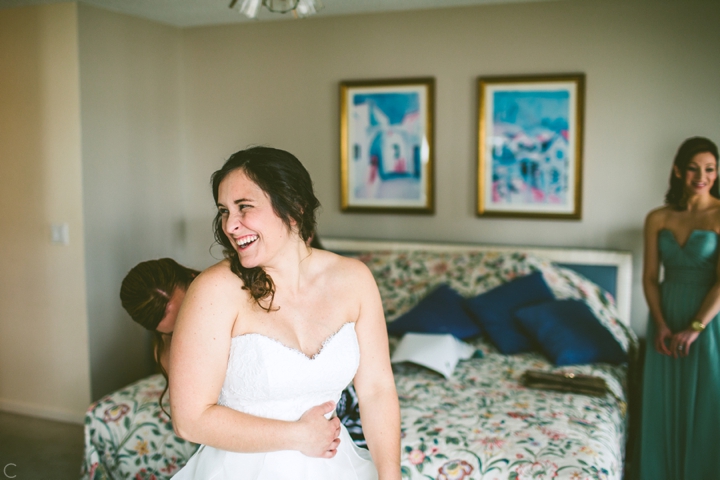 Bride putting on dress