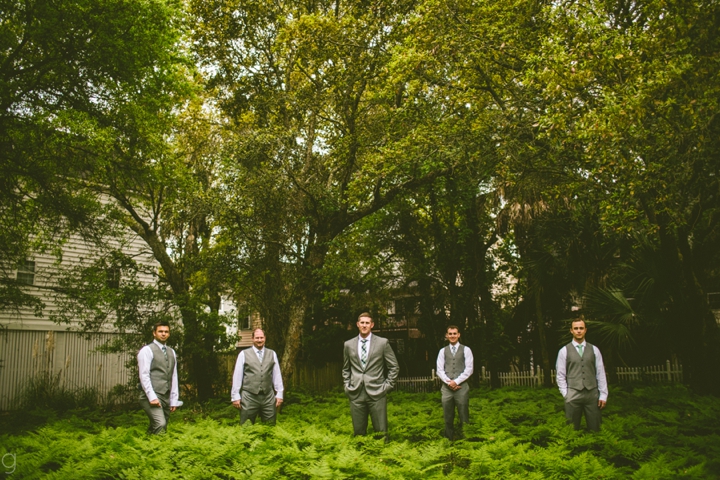 Groomsmen standing in ferns