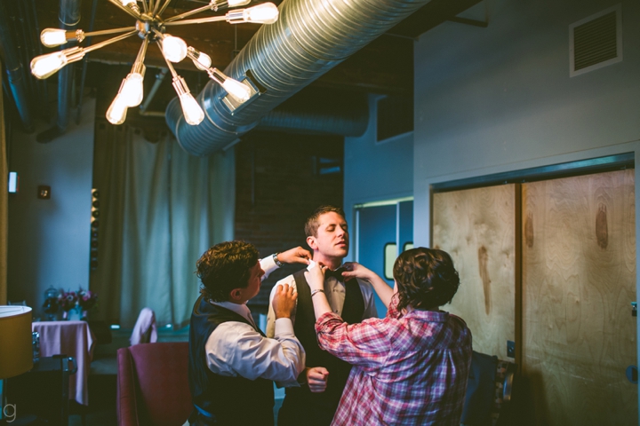 Groom putting on bow tie