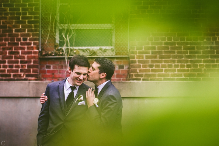 Grooms kissing same sex wedding