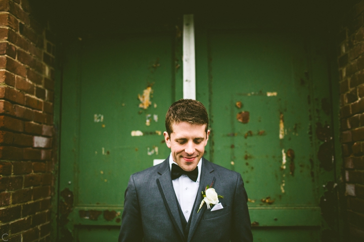 Groom portrait green wall