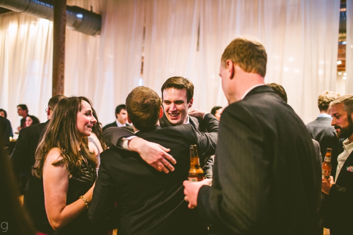 Groom hugging wedding guests