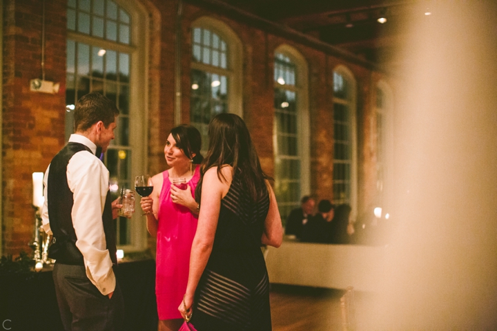 Wedding guests talking to groom