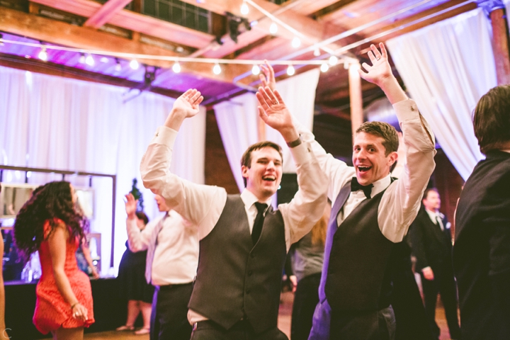 Grooms dancing at wedding
