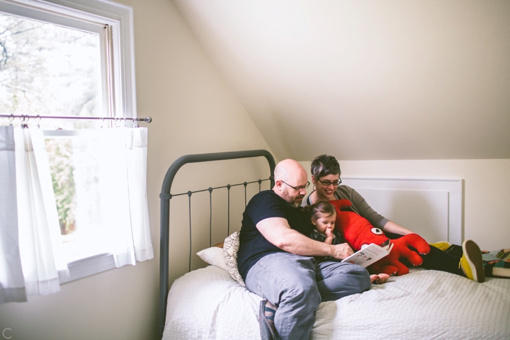 child reading with parents