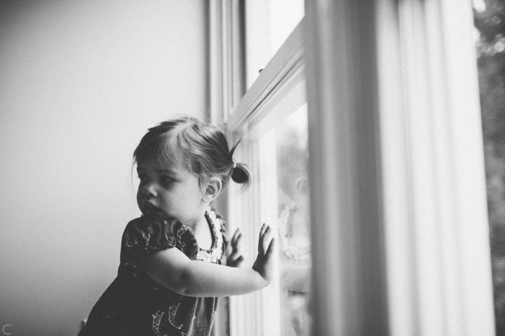 little girl looking out window