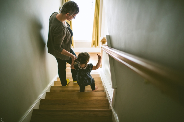 mom walking child down the stairs
