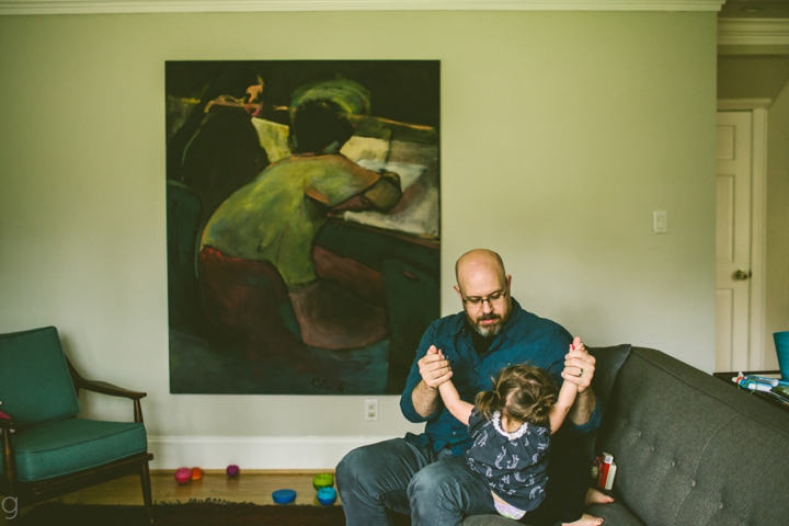 dad playing with daughter on couch