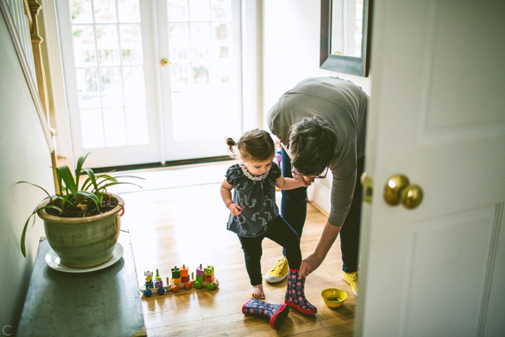 kid putting on rain boots