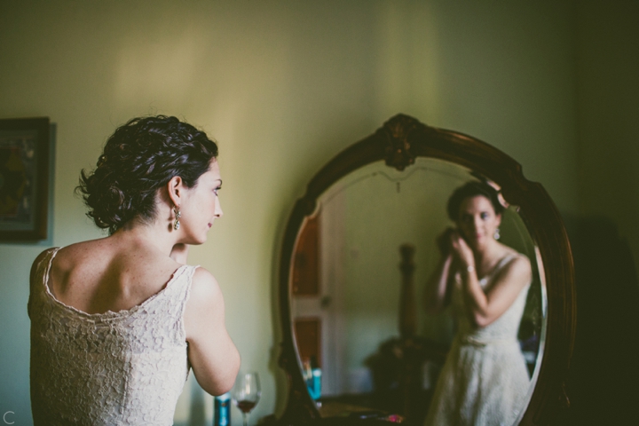 Bride putting on earrings