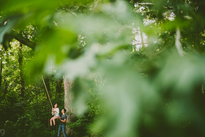 Guy pushing girl on swing