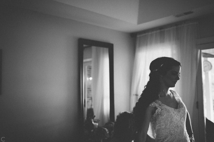 Bride putting on dress