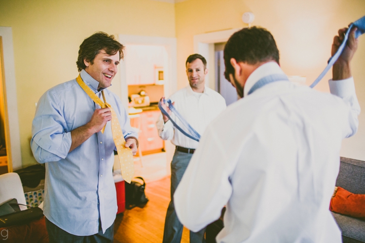 groomsmen putting on ties