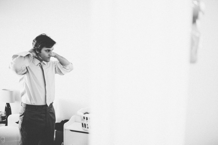 groom putting on tie