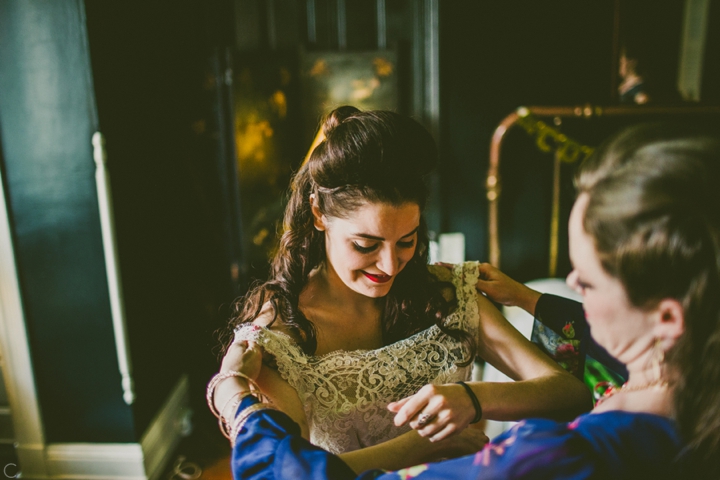 bride putting on dress