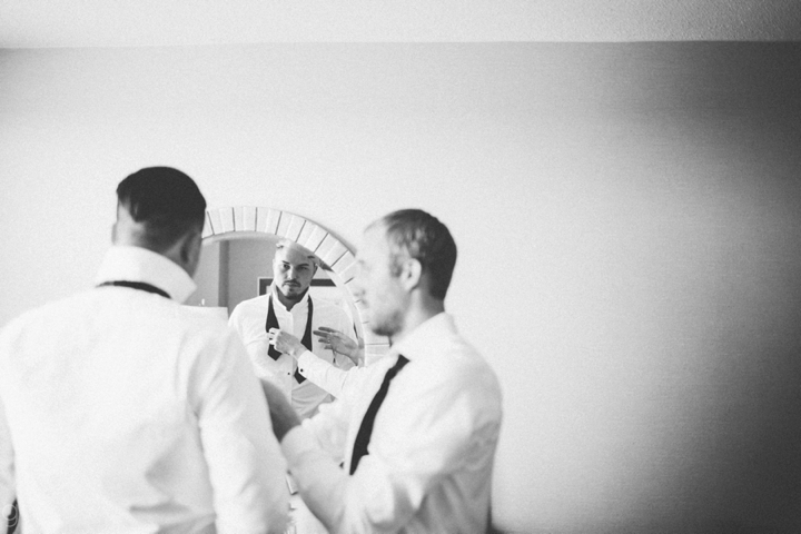 Groom putting on bow tie