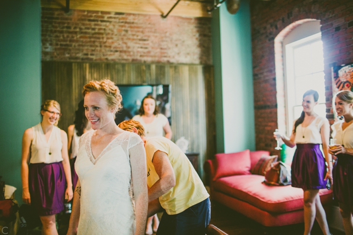 bride putting on dress