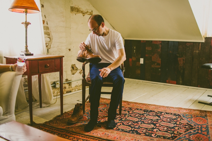 Groom putting on shoes