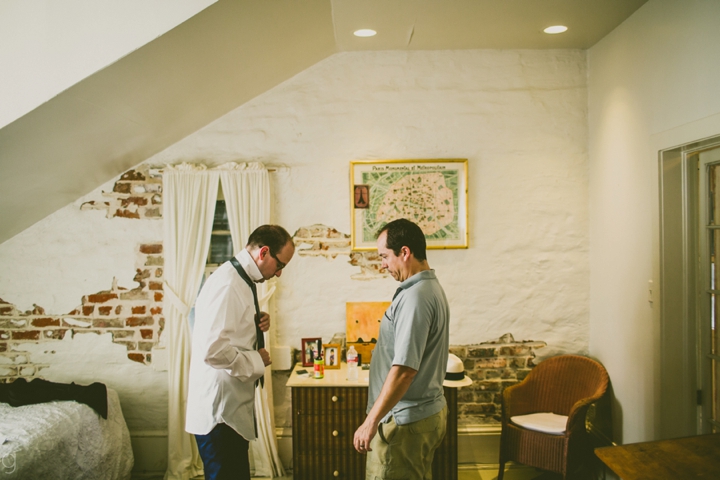 Groom tying tie