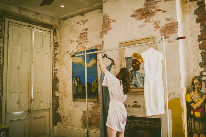 Bride getting dress off hanger