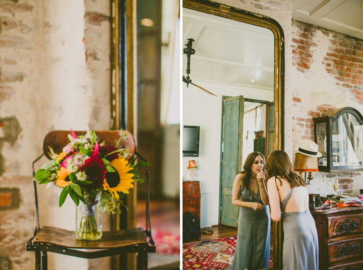 Bride putting on lipstick and sunflower bouquet