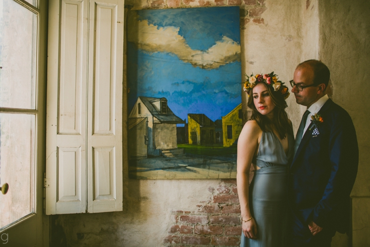 Bride and groom standing near window