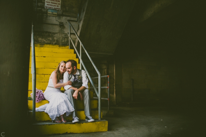 Bride and groom sitting on stairs