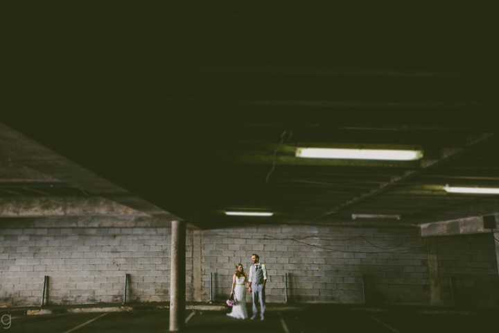 Bride and groom in parking garage