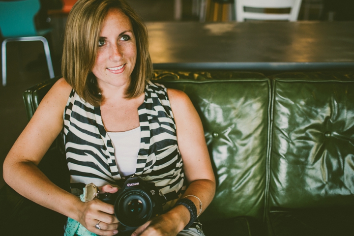 Woman holding camera on couch