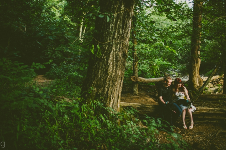 Couple sitting on log in the Eno