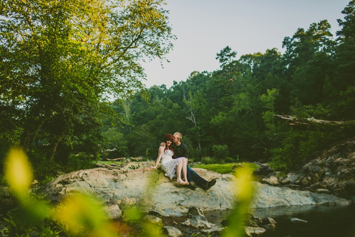 Couple sitting on rocks in the Eno