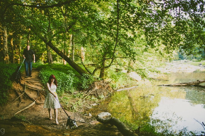 Couple walking dogs along water