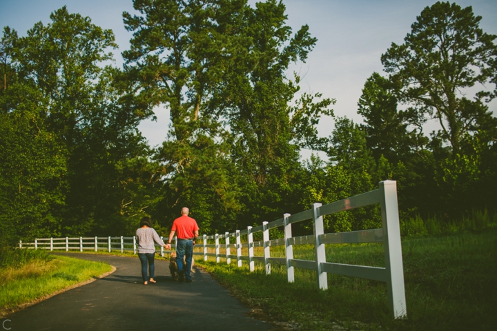 Husband and wife walking next to fence