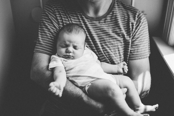 Sleeping baby in dad's arms