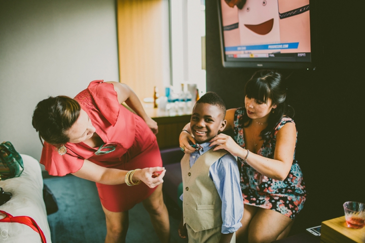 Ring bearer putting on bowtie