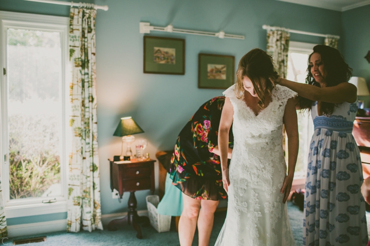 Bride putting on dress