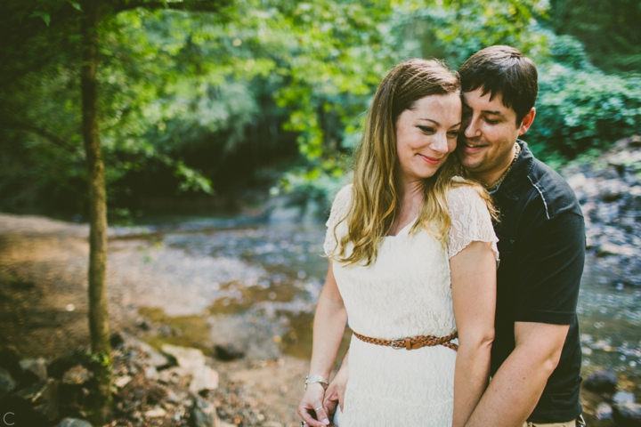 Couple standing by creek