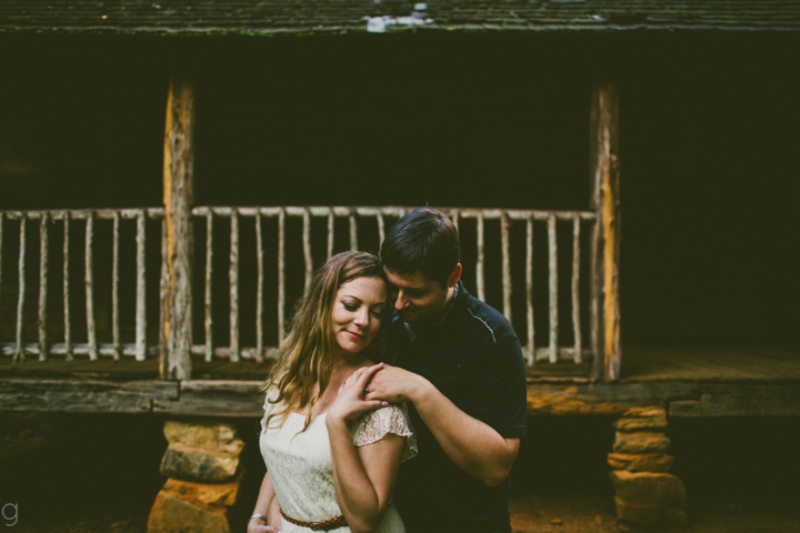 Couple standing by cottage