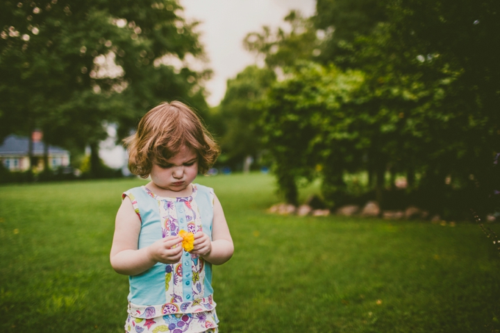 Girl looking at flower