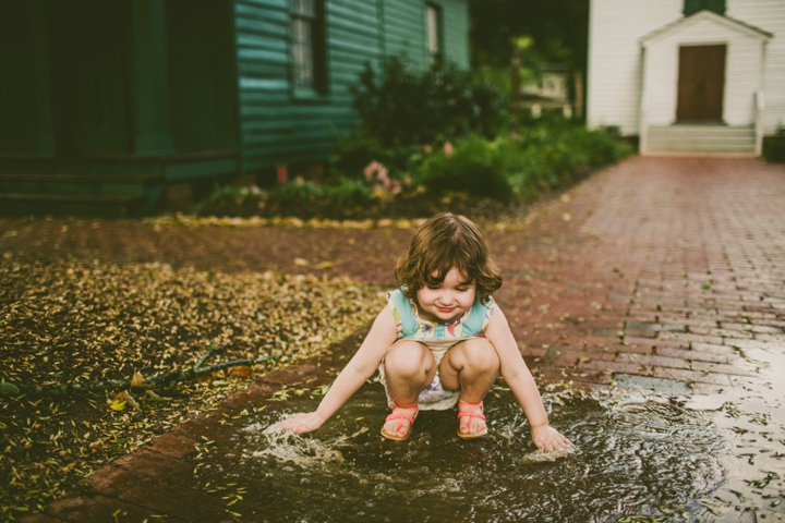 Child playing in puddle