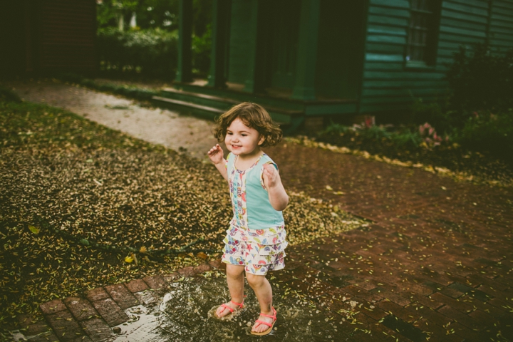 Kid jumping in puddle